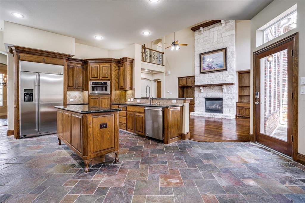 1212 Rio Grande Court Allen, TX 75013 - Photo 12 of 34 a kitchen with stainless steel appliances granite countertop a refrigerator and a stove top oven