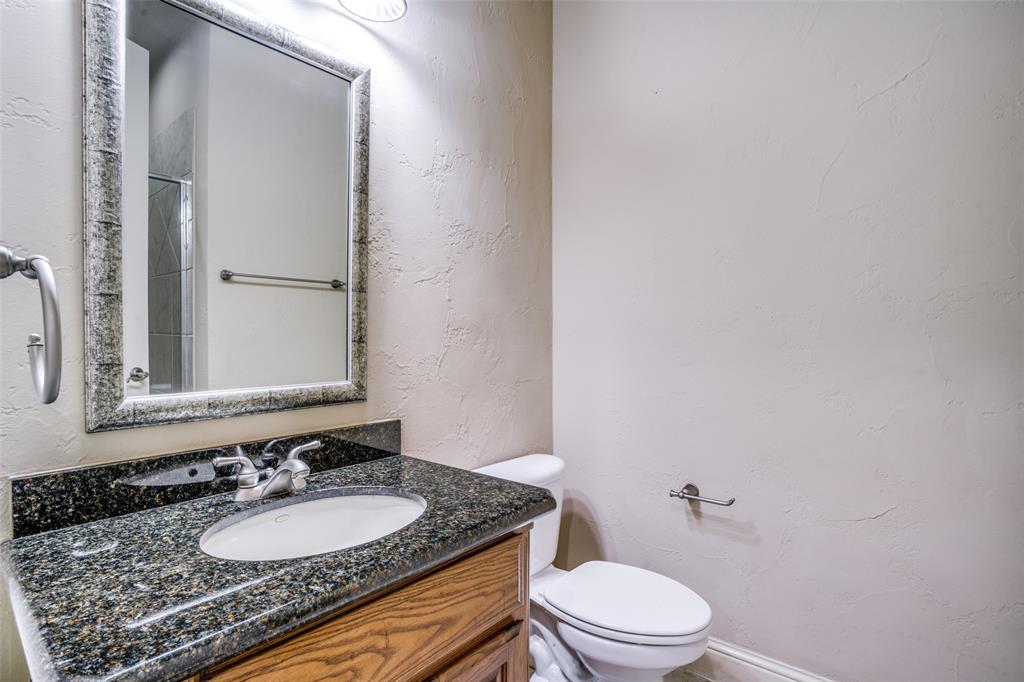1212 Rio Grande Court Allen, TX 75013 - Photo 16 of 34 a bathroom with a granite countertop sink a toilet and a mirror