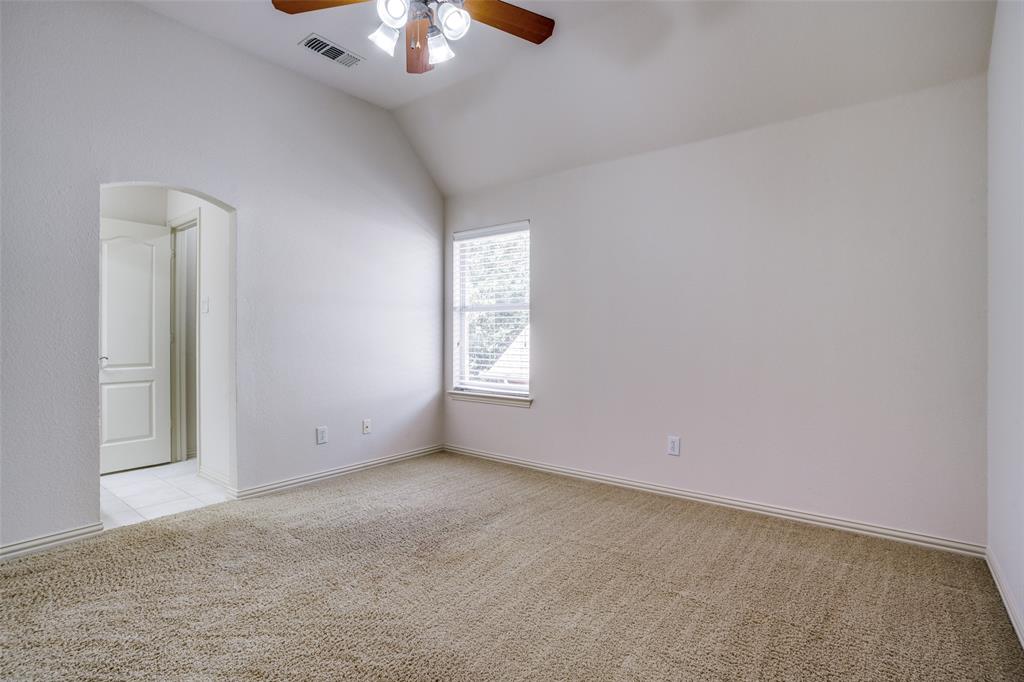 1212 Rio Grande Court Allen, TX 75013 - Photo 22 of 34 an empty room with a chandelier fan and windows