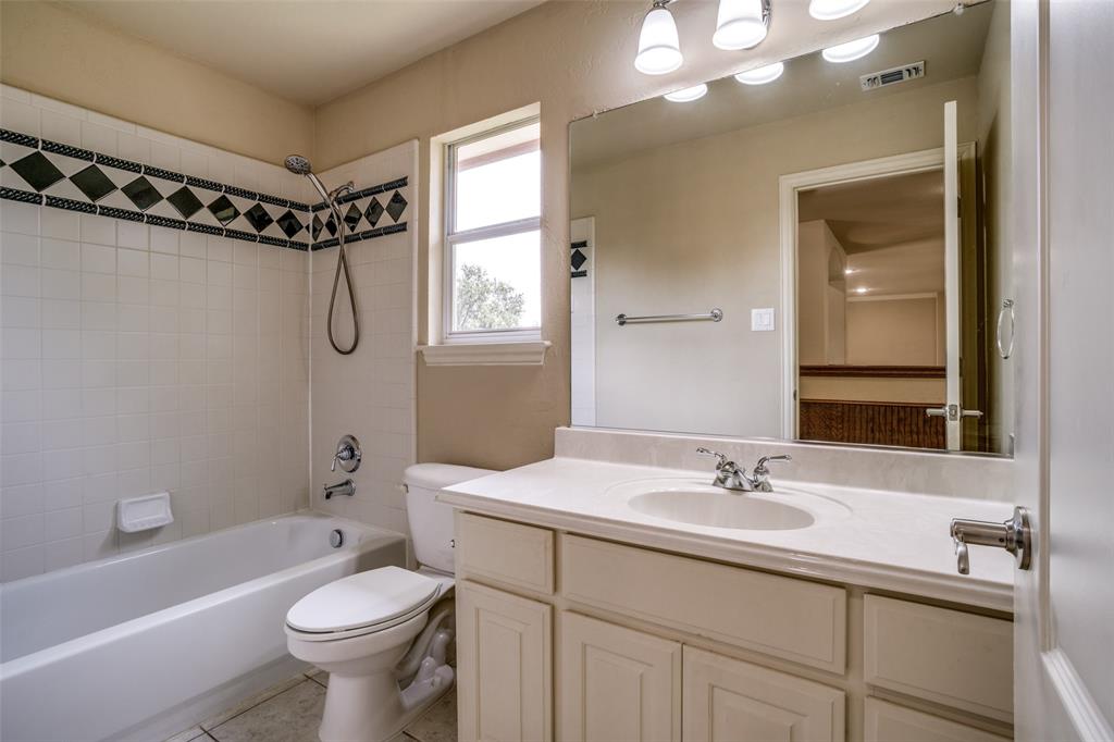 1212 Rio Grande Court Allen, TX 75013 - Photo 29 of 34 a bathroom with a sink toilet a mirror and shower