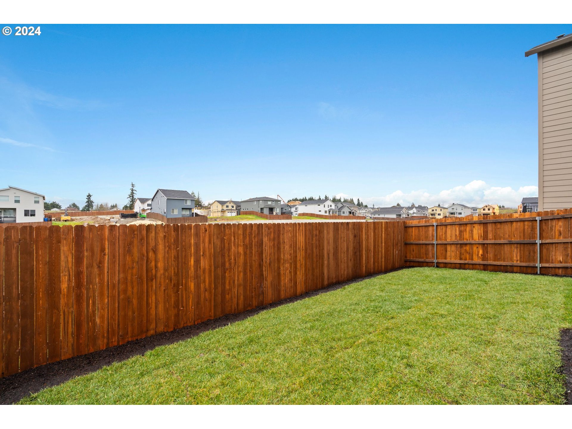 910 Northwest 175th Way Ridgefield, WA 98642 - Photo 13 of 16 a view of a yard with wooden fence