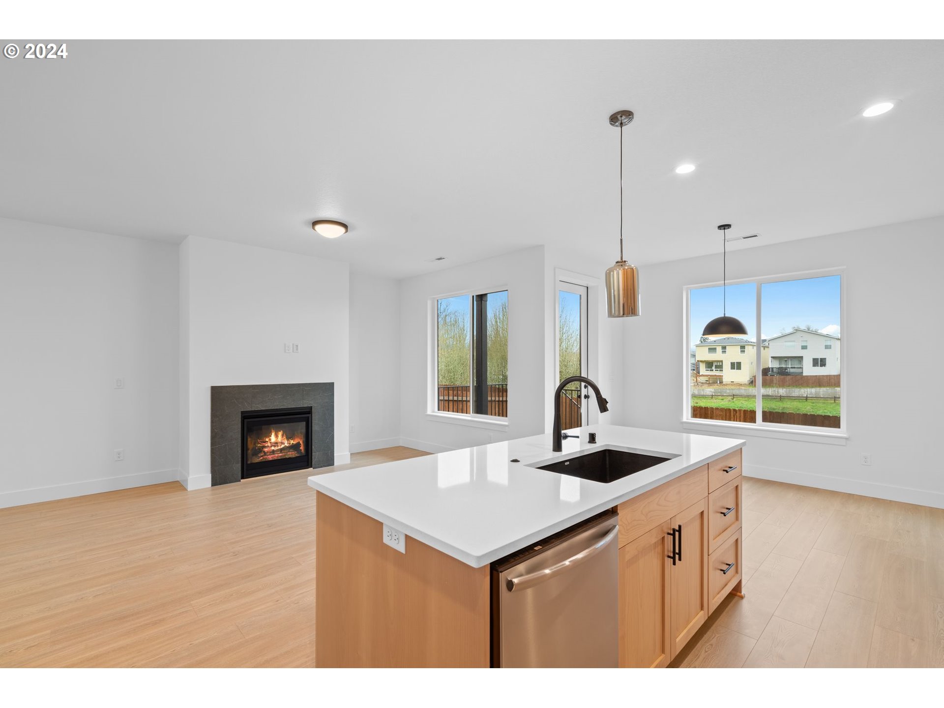 910 Northwest 175th Way Ridgefield, WA 98642 - Photo 3 of 16 a kitchen with kitchen island granite countertop a stove a sink a counter space and cabinets