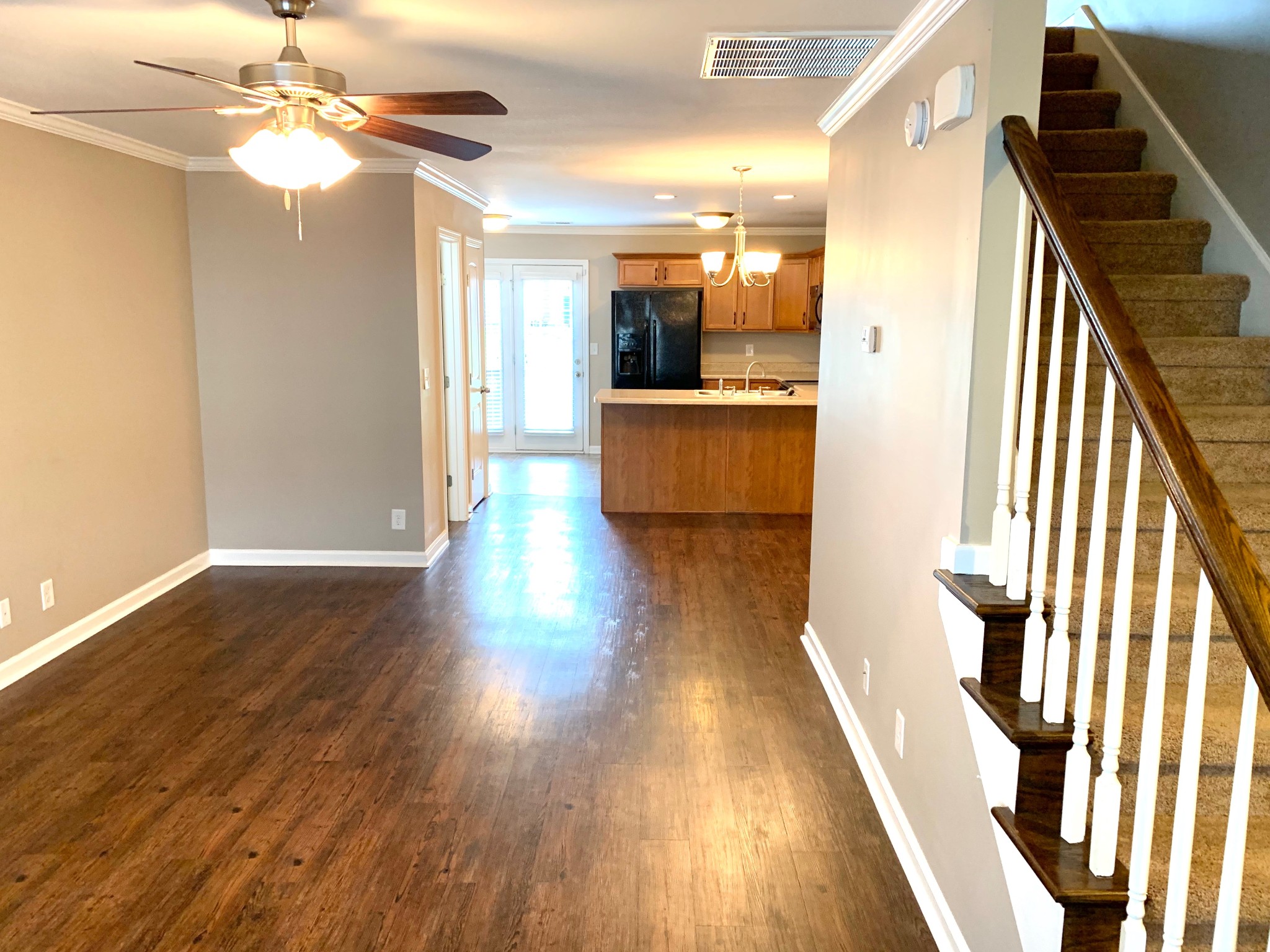 318 Sam Houston Circle Clarksville, TN 37040 - Photo 3 of 20 a view of a hallway with wooden floor a ceiling fan and entryway