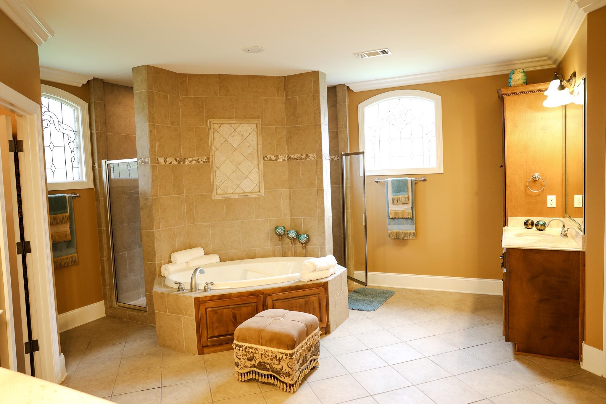 649 Ridge Springs Road Collierville, TN 38017 - Photo 21 of 35 Full bath with a shower stall, vanity, crown molding, a garden tub, and light tile patterned floors
