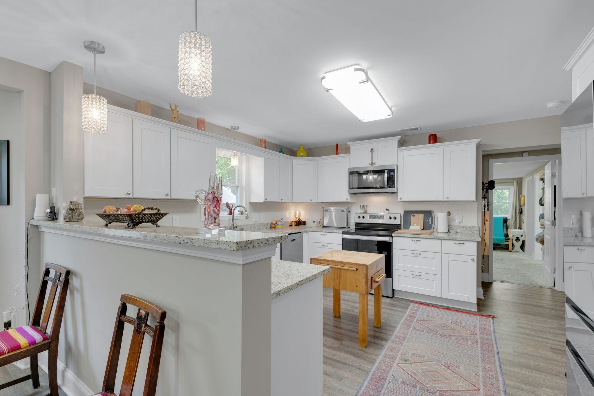 610 Polk Street Manchester, TN 37355 - Photo 11 of 30 a kitchen with kitchen island a stove a table and chairs in it