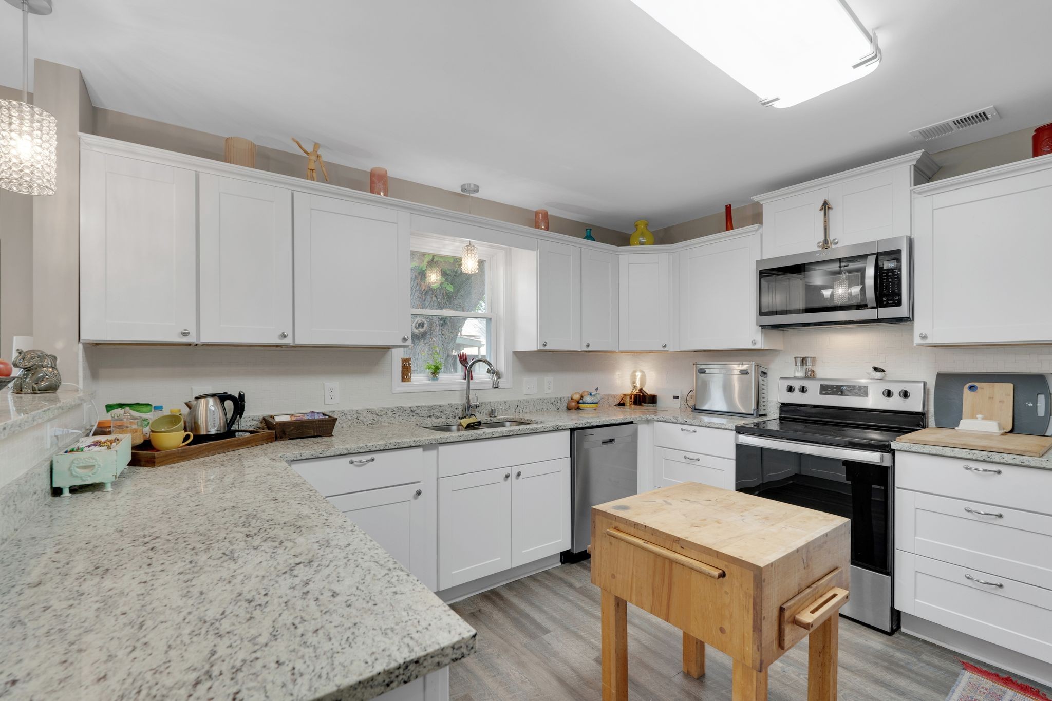 610 Polk Street Manchester, TN 37355 - Photo 12 of 30 a kitchen with stainless steel appliances granite countertop a sink a stove top oven a counter space and cabinets