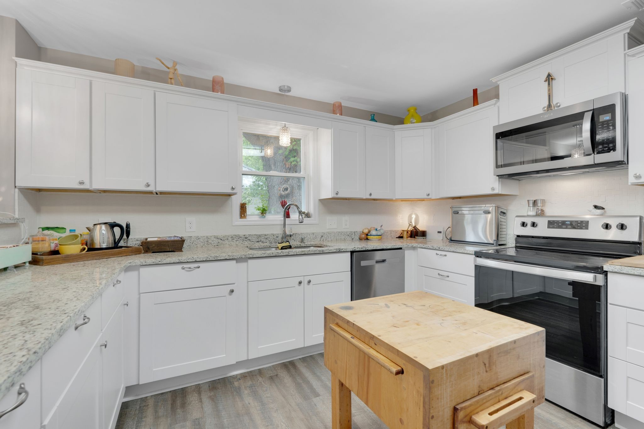 610 Polk Street Manchester, TN 37355 - Photo 13 of 30 a kitchen with stainless steel appliances granite countertop a sink and dishwasher a stove top oven with white cabinets