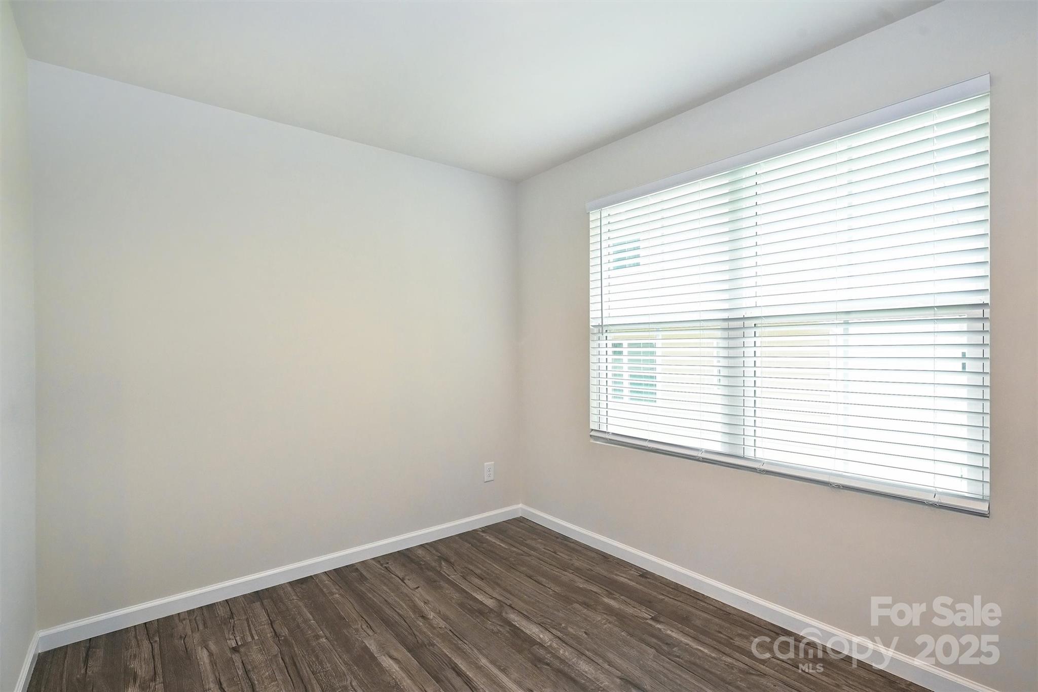 825 Renee Avenue Fort Mill, SC 29715 - Photo 14 of 30 a view of an empty room with wooden floor and a window
