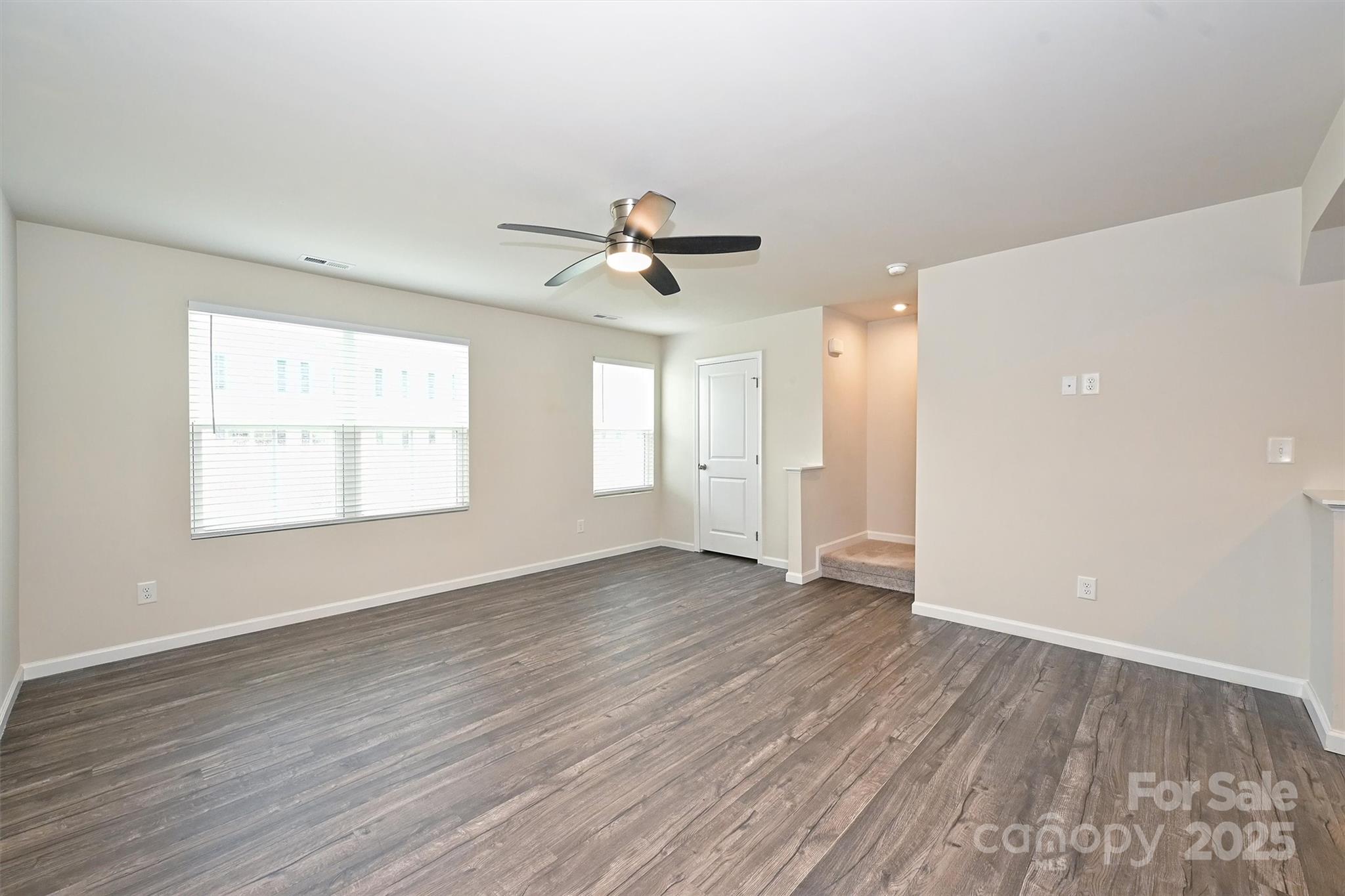 825 Renee Avenue Fort Mill, SC 29715 - Photo 15 of 30 an empty room with wooden floor and windows