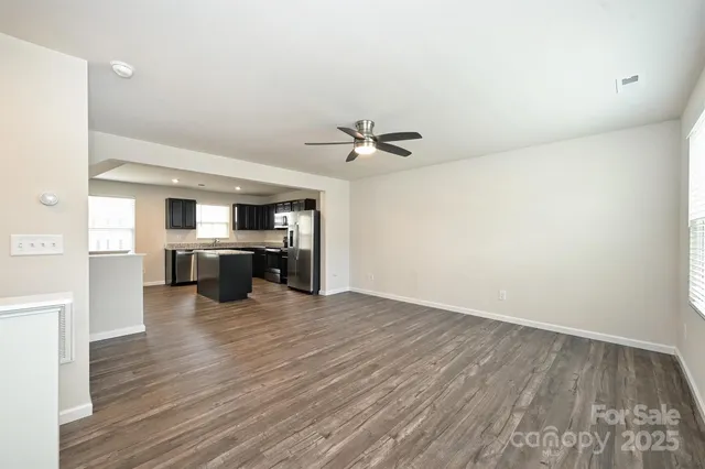 a view of a kitchen with a sink and a refrigerator