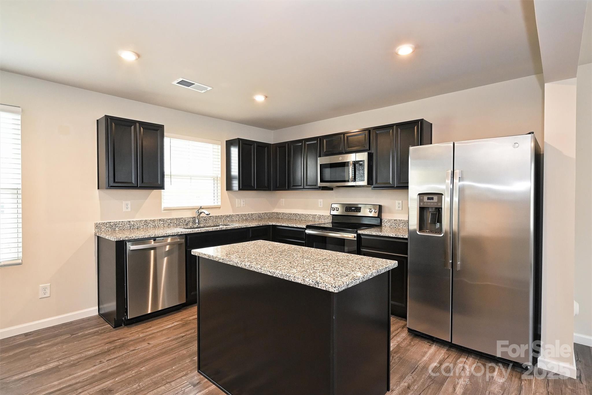 825 Renee Avenue Fort Mill, SC 29715 - Photo 9 of 30 a kitchen with stainless steel appliances granite countertop a refrigerator a sink a stove a microwave and island