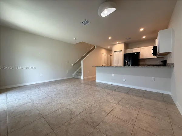 an empty room with a kitchen and a sink