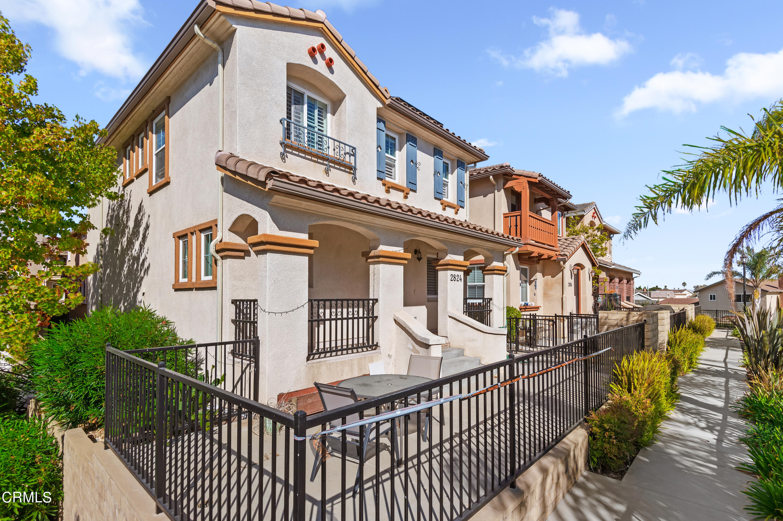 2824 Yacht Way Oxnard, CA 93035 - Photo 1 of 24 a view of a brick house with large windows and a small yard