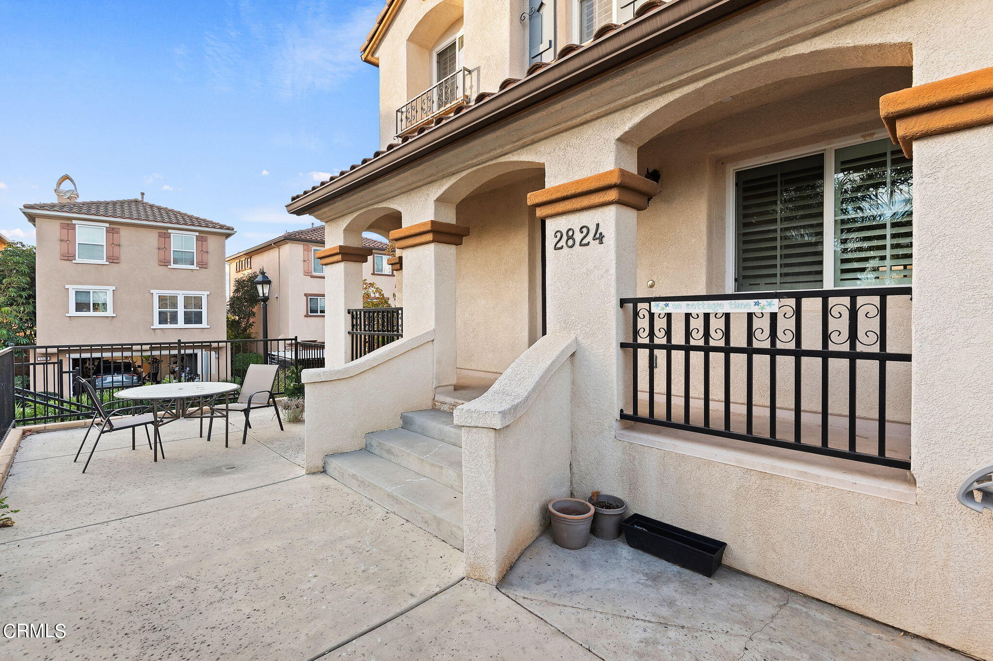 2824 Yacht Way Oxnard, CA 93035 - Photo 2 of 24 a view of a patio with a table and chairs and potted plants