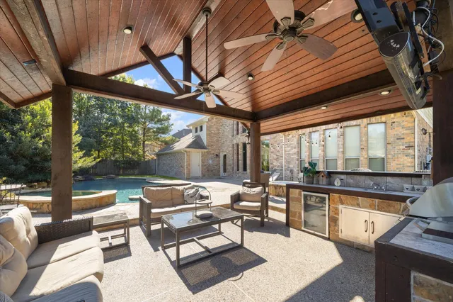 a living room with patio furniture and a floor to ceiling window