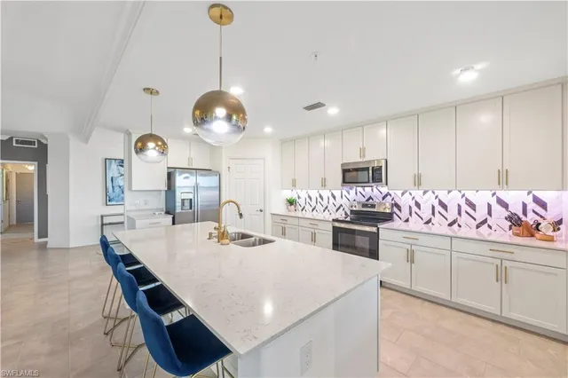 a large kitchen with a table and chairs