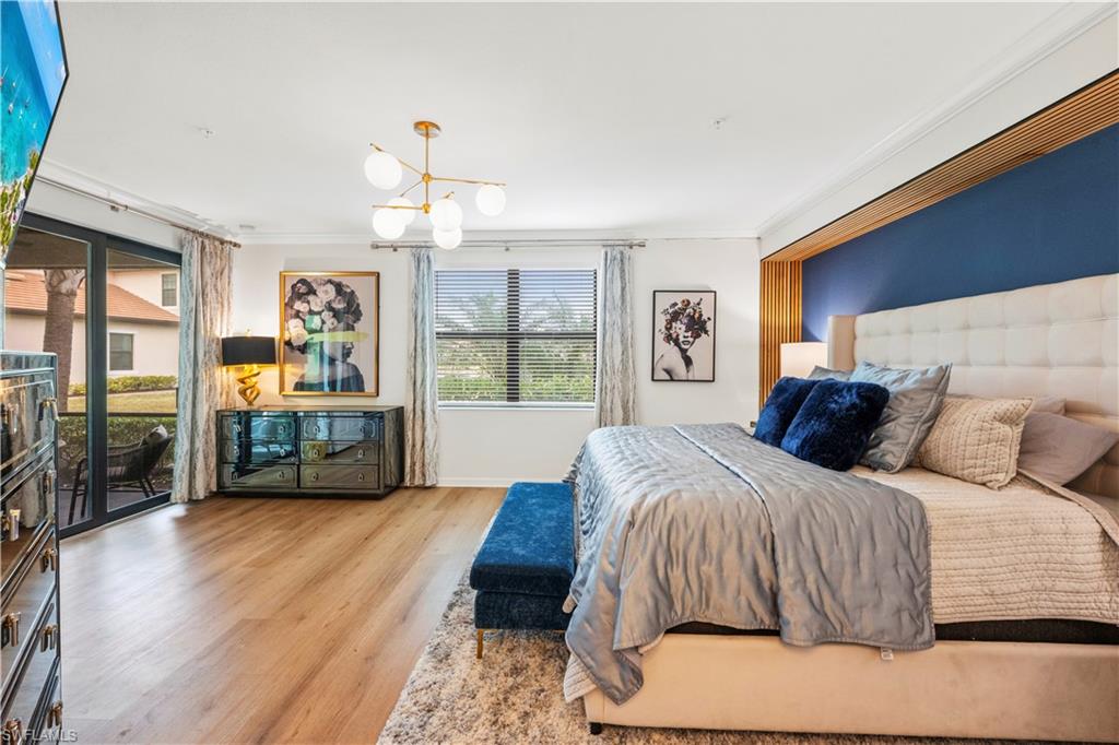2373 Anguilla Drive, Unit 101 Naples, FL 34120 - Photo 14 of 32 a bedroom with a large bed and a window
