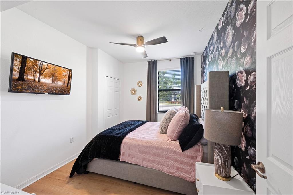 2373 Anguilla Drive, Unit 101 Naples, FL 34120 - Photo 18 of 32 a bedroom with a bed and window