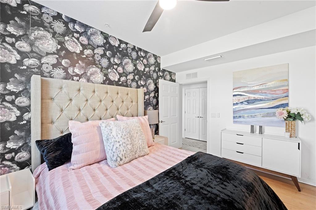 2373 Anguilla Drive, Unit 101 Naples, FL 34120 - Photo 19 of 32 a bedroom with a bed and a window