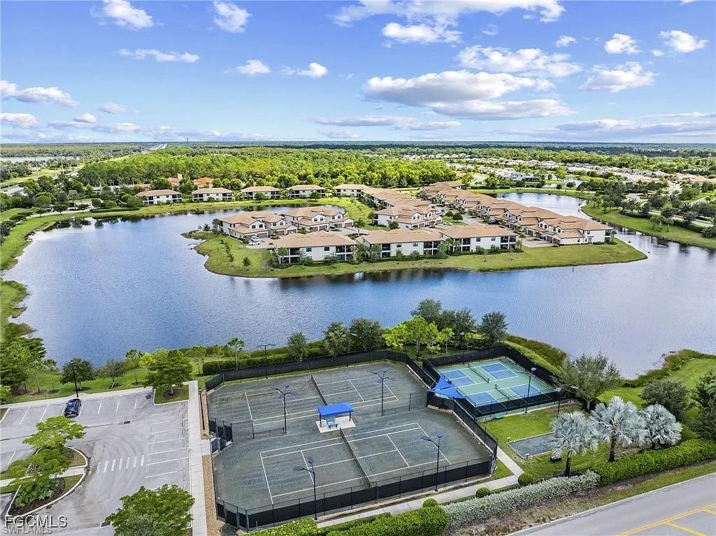 2373 Anguilla Drive, Unit 101 Naples, FL 34120 - Photo 27 of 32 an aerial view of residential houses with outdoor space and lake view