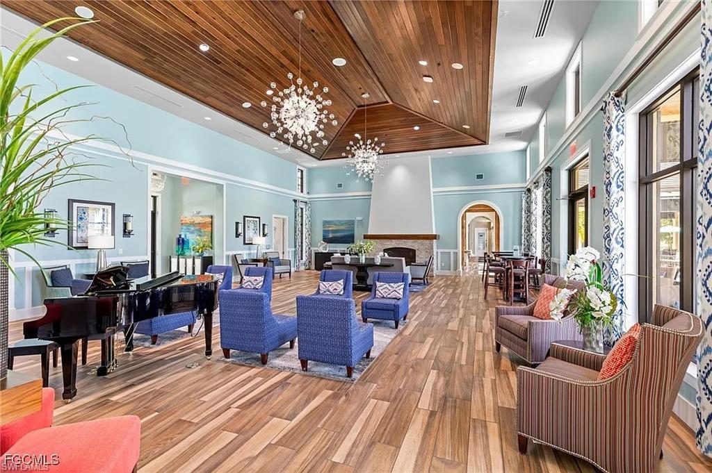 2373 Anguilla Drive, Unit 101 Naples, FL 34120 - Photo 28 of 32 a living room with lots of furniture and chandelier