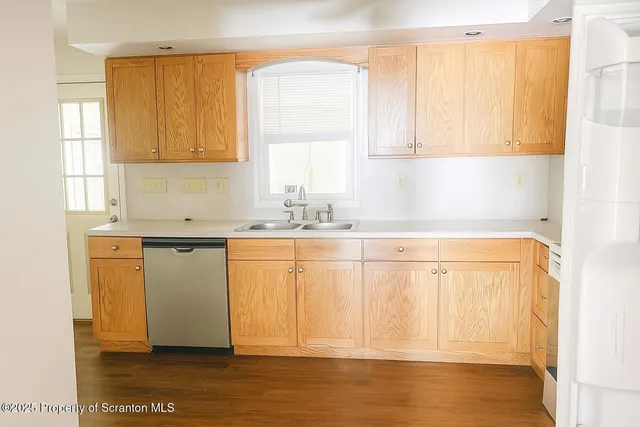 a bathroom with a sink a window and a mirror