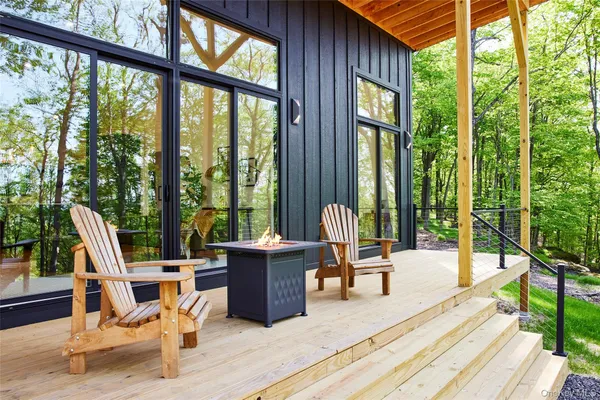 a view of a patio with a table chairs and backyard