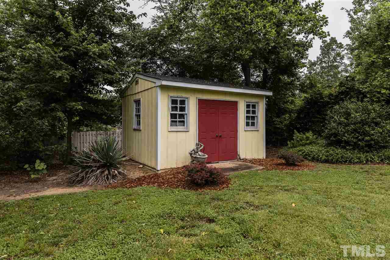 3929 Haithcock Road Raleigh, NC 27604 - Photo 11 of 11 a backyard of a house with table and chairs