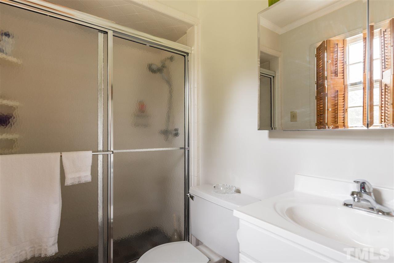 3929 Haithcock Road Raleigh, NC 27604 - Photo 6 of 11 a bathroom with a bathtub shower sink vanity and toilet