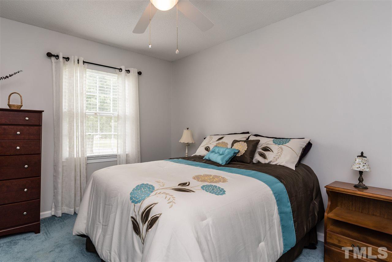 3929 Haithcock Road Raleigh, NC 27604 - Photo 7 of 11 a bedroom with a bed and a window