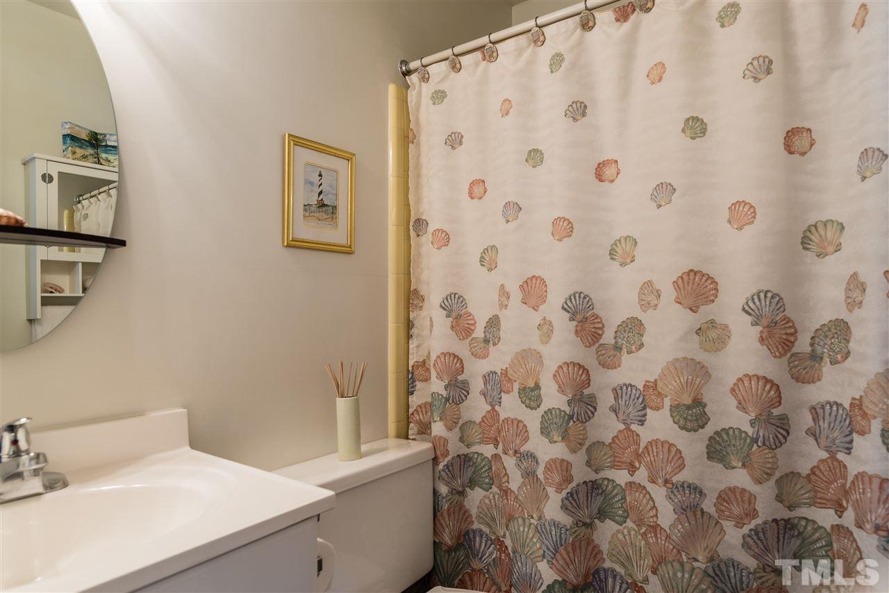 3929 Haithcock Road Raleigh, NC 27604 - Photo 9 of 11 a bathroom with a sink toilet and shower