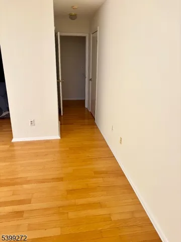 a view of hallway with wooden floor