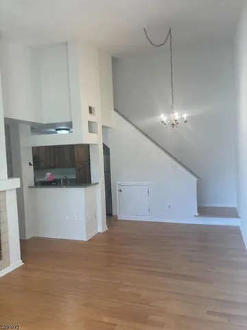 a view of a room with an empty kitchen