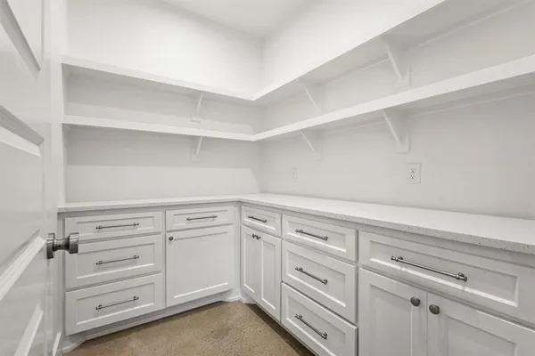 a kitchen with cabinets stainless steel appliances and a counter space