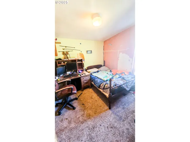 a bed room with a bed and a large window