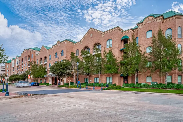 front view of house with a yard and a car parked on the road