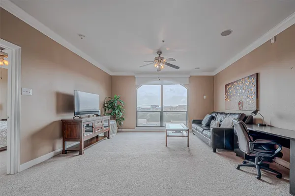 a view of a livingroom with workspace and a window