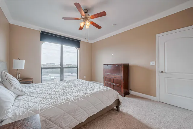 a bedroom with a bed and a large window