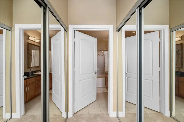 a view of a hallway with closet and a living room