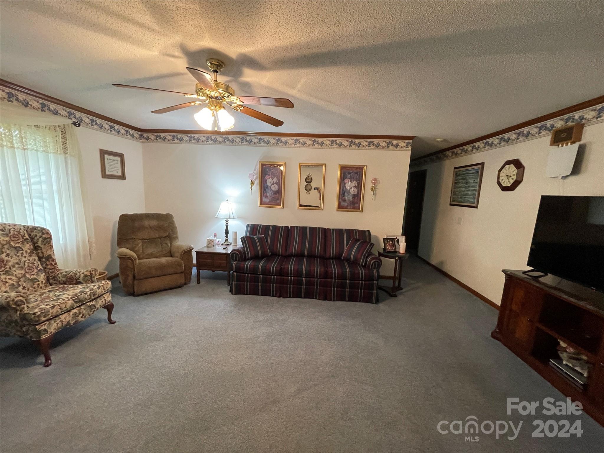 36345 Old Salisbury Road New London, NC 28127 - Photo 14 of 48 a living room with furniture a couch and a flat screen tv