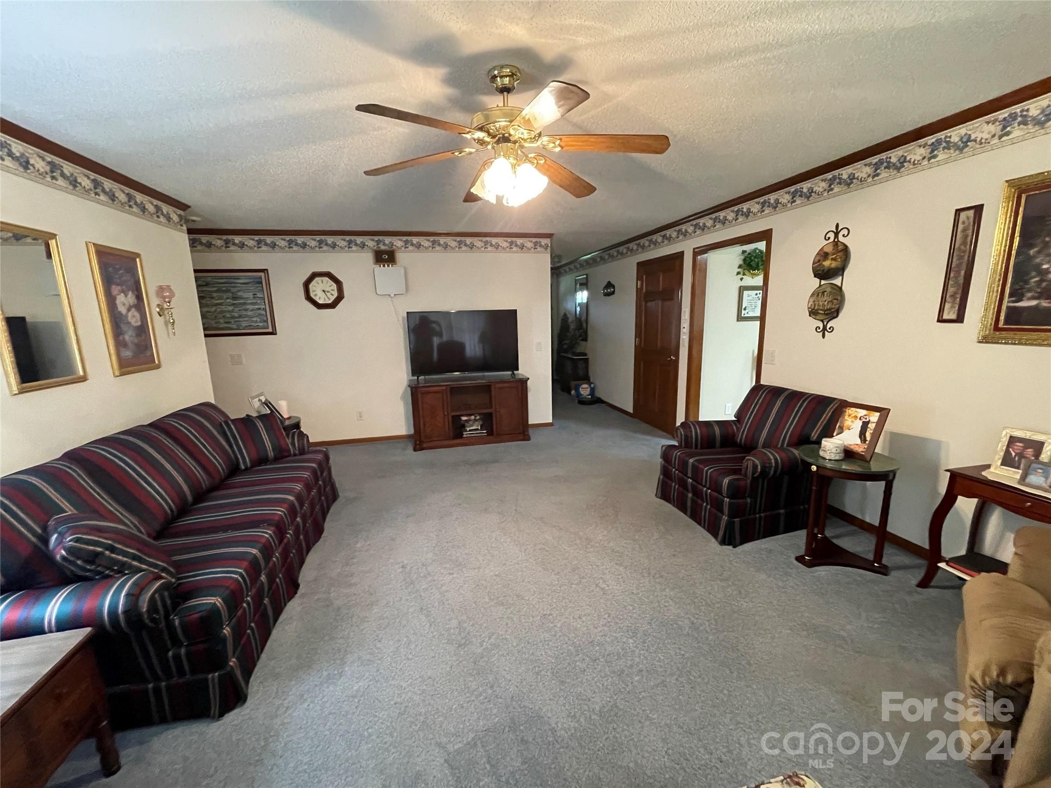 36345 Old Salisbury Road New London, NC 28127 - Photo 16 of 48 a living room with furniture and a flat screen tv