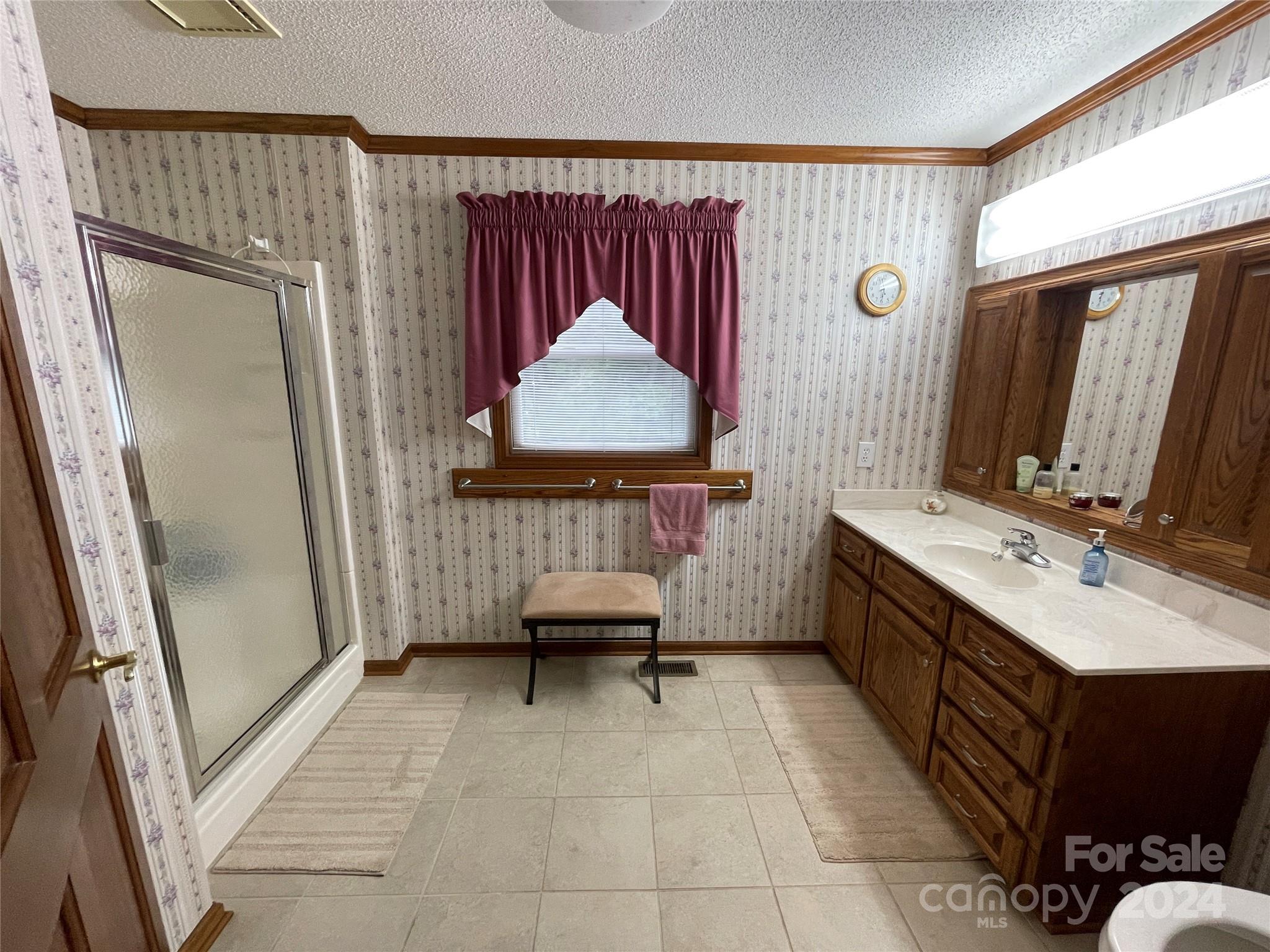 36345 Old Salisbury Road New London, NC 28127 - Photo 24 of 48 a bathroom with a sink a mirror and a shower