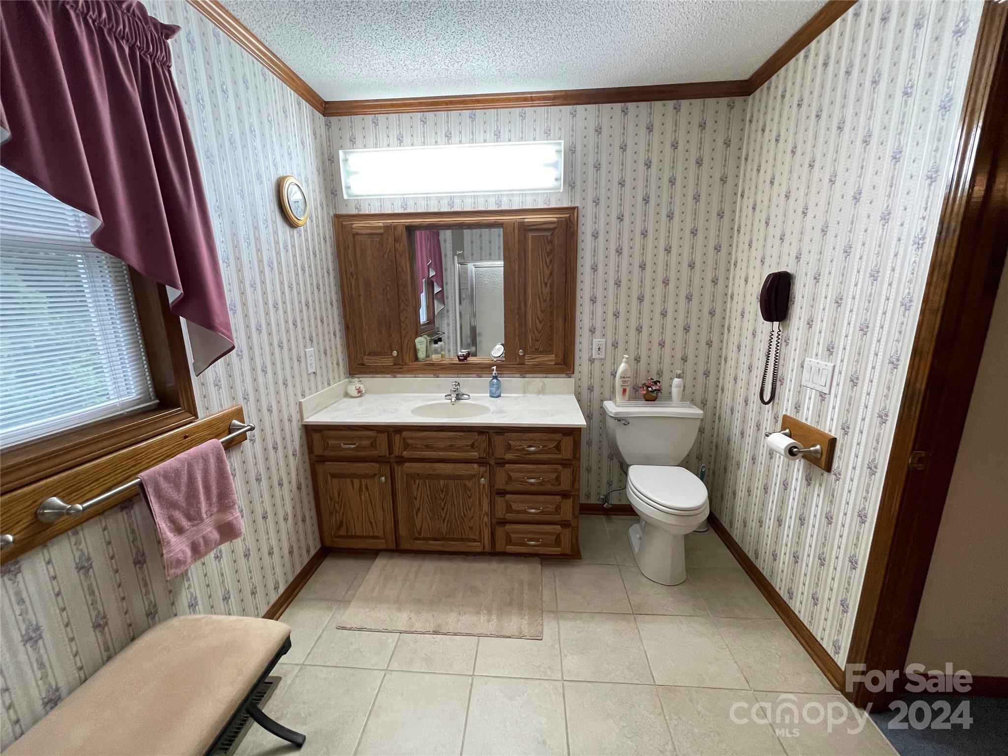 36345 Old Salisbury Road New London, NC 28127 - Photo 25 of 48 a bathroom with a sink a toilet and mirror
