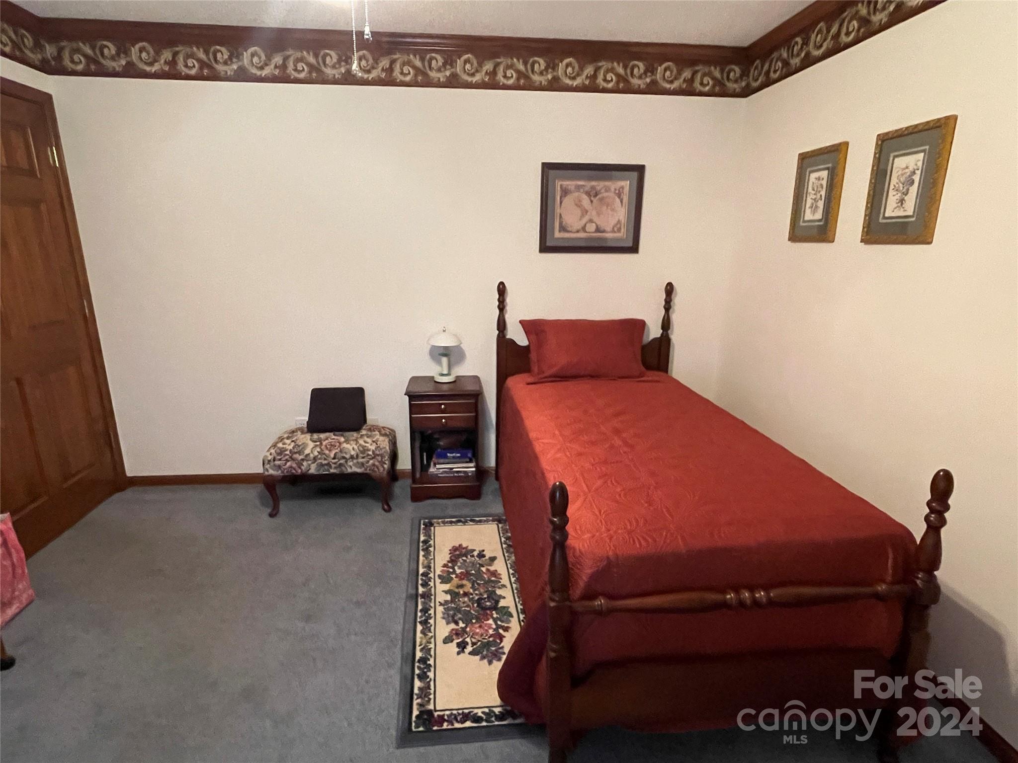 36345 Old Salisbury Road New London, NC 28127 - Photo 26 of 48 a bedroom with a bed and a wall painting