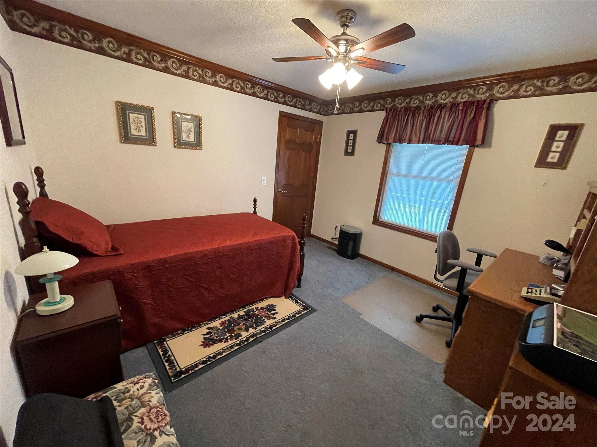 36345 Old Salisbury Road New London, NC 28127 - Photo 28 of 48 a bedroom with a bed and a chandelier