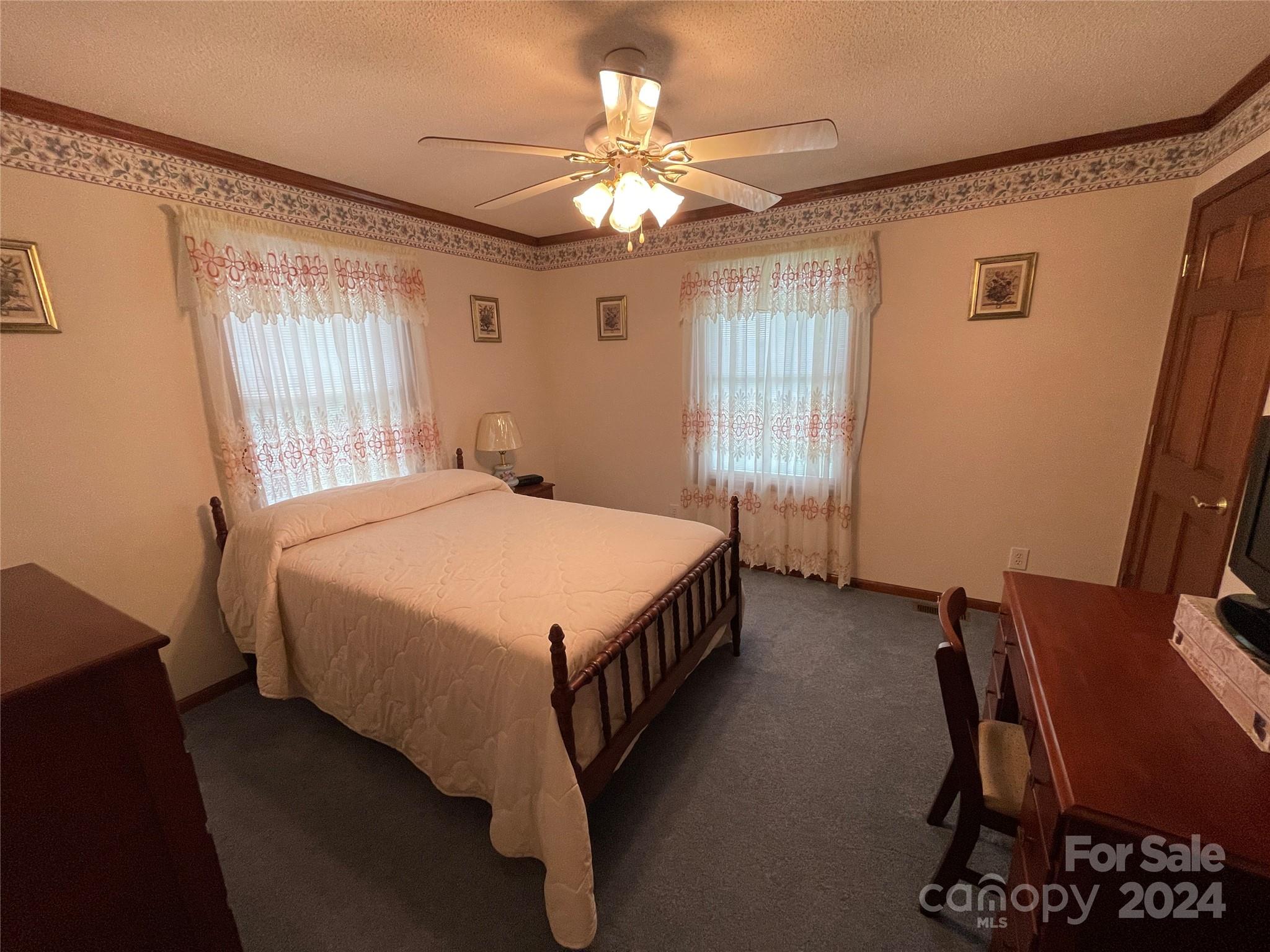 36345 Old Salisbury Road New London, NC 28127 - Photo 29 of 48 a spacious bedroom with a bed table and window