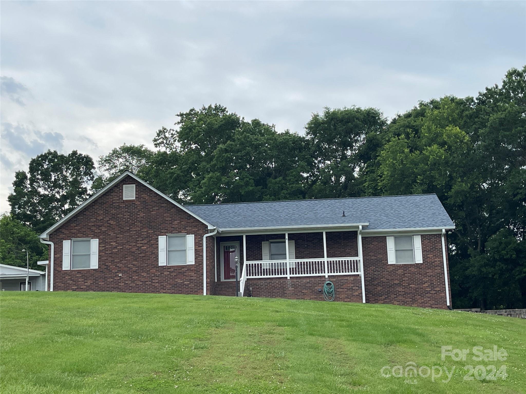 36345 Old Salisbury Road New London, NC 28127 - Photo 3 of 48 a front view of a house with a yard