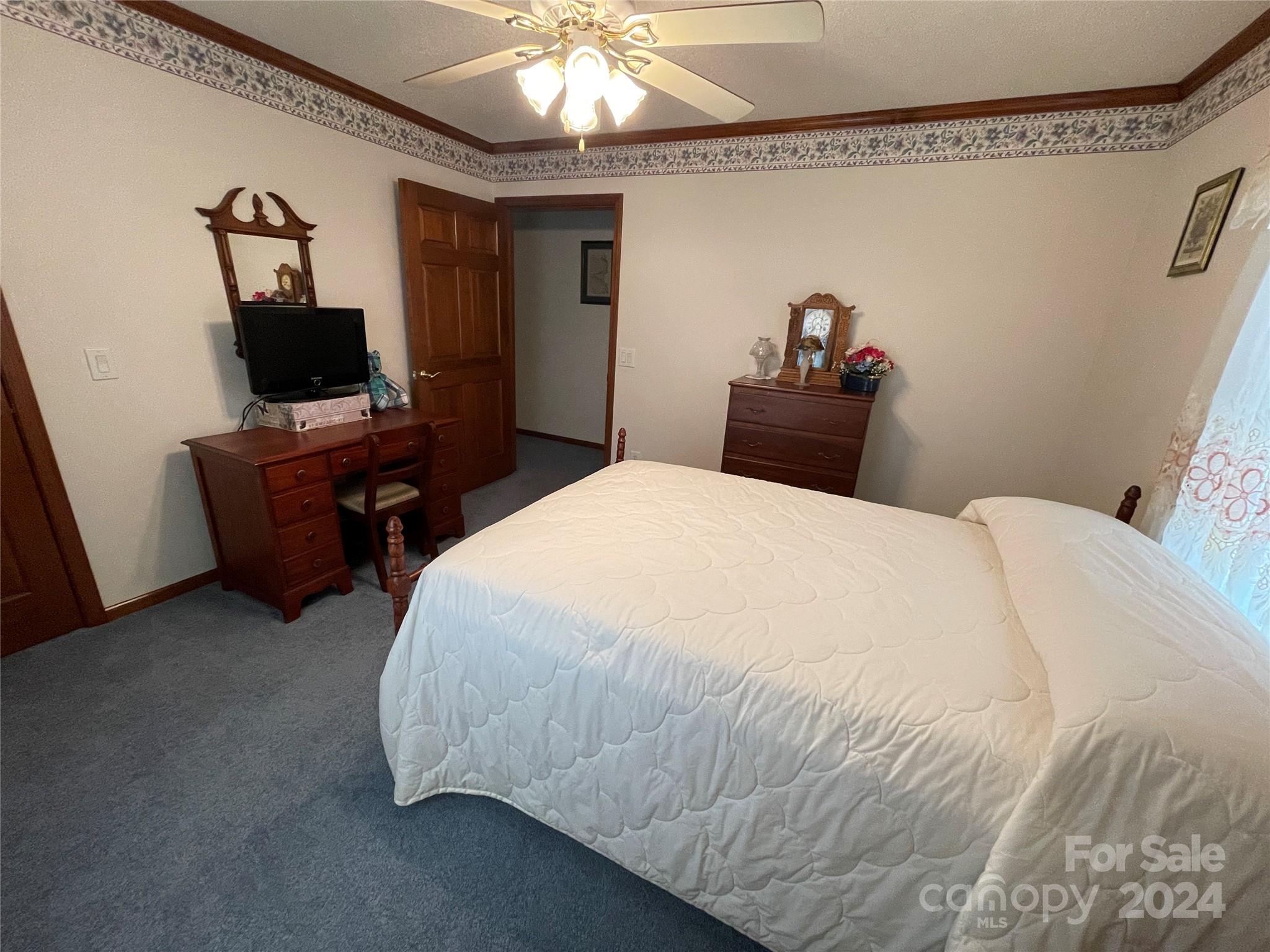 36345 Old Salisbury Road New London, NC 28127 - Photo 31 of 48 a bedroom with a bed and a flat screen tv