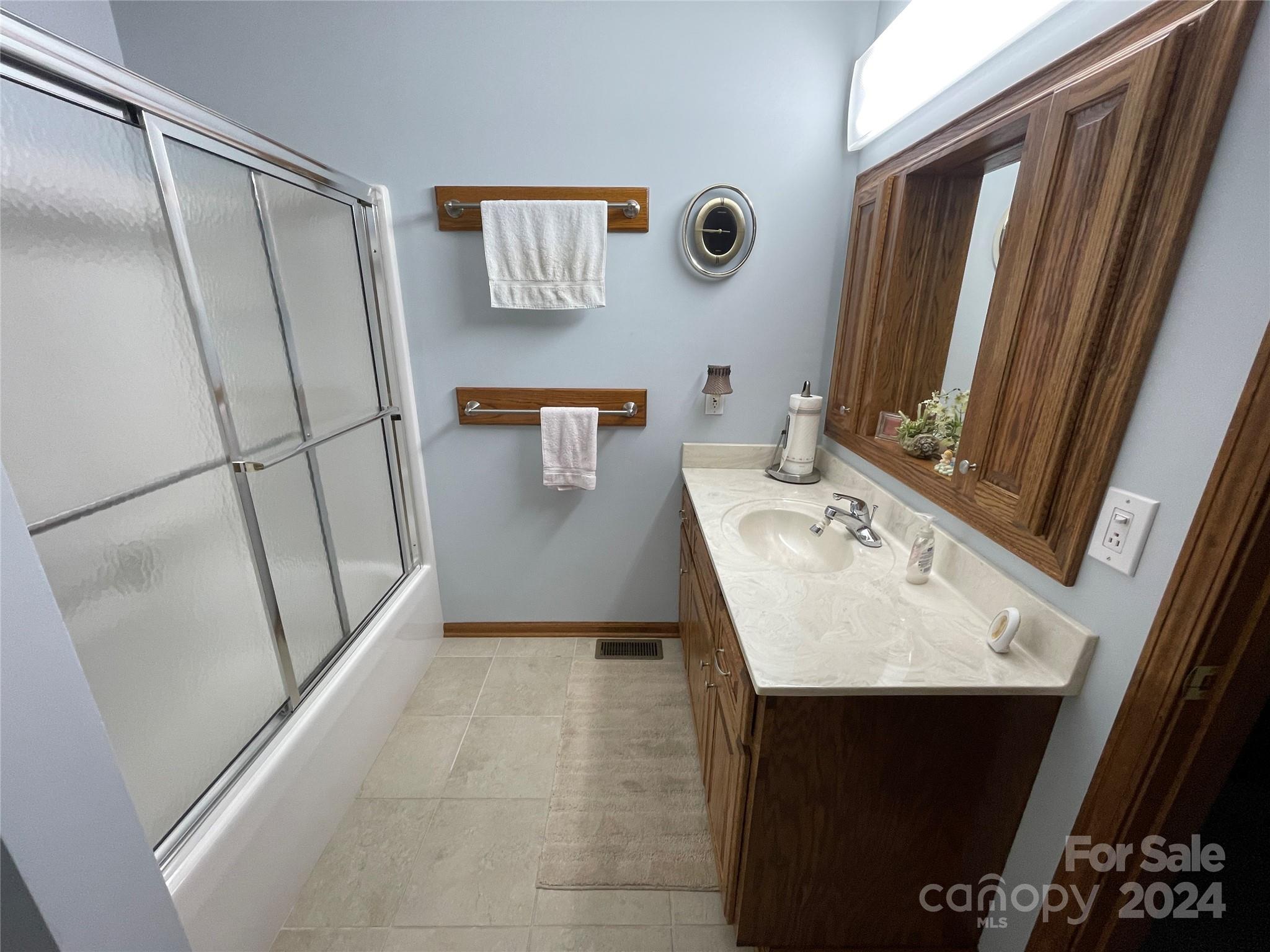 36345 Old Salisbury Road New London, NC 28127 - Photo 32 of 48 a bathroom with a sink a mirror and a shower