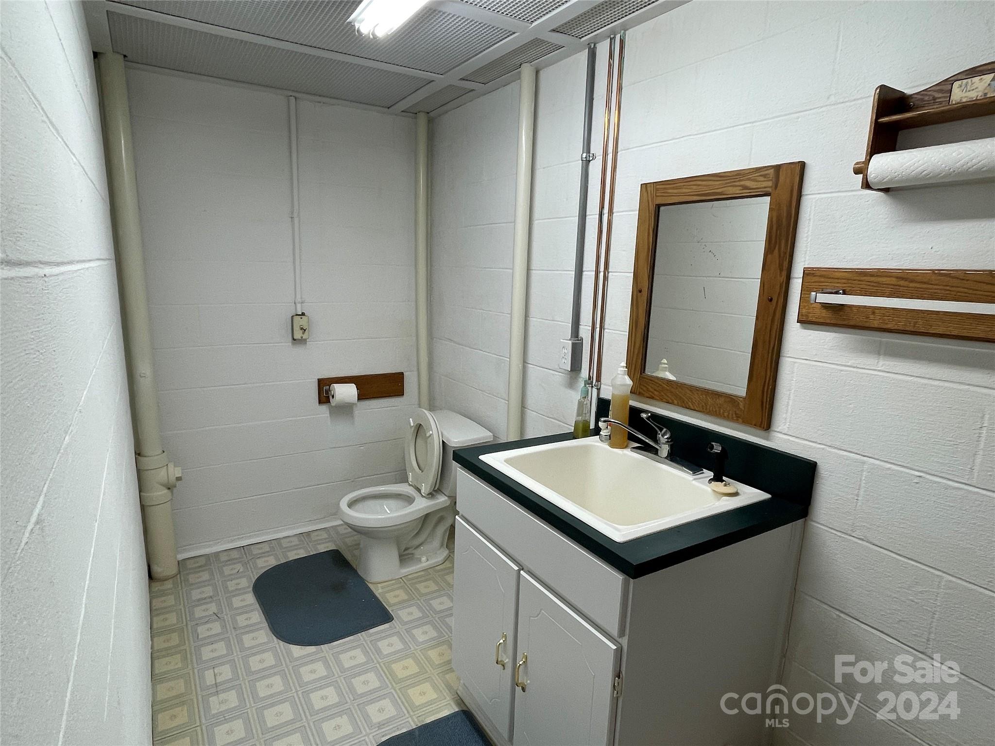 36345 Old Salisbury Road New London, NC 28127 - Photo 40 of 48 a bathroom with a granite countertop sink and a mirror